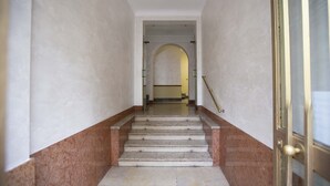 A marble staircase with a handrail leading to a doorway. - Casa Gabel by Wonderful Italy (Torino)