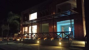 A building with a covered entrance area, a visible door, and a staircase leading up to the entrance. - Santa Areia Lençóis Pousada (Santo Amaro do Maranhão)
