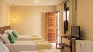 A hotel room with four single beds, a small desk with a television, and a refrigerator. - Santa Areia Lençóis Pousada (Santo Amaro do Maranhão)