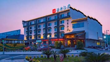 A multi-story hotel with a modern facade, multiple balconies, and a prominent entrance.