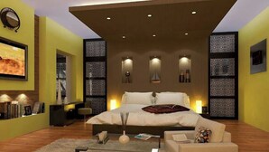 A modern bedroom with a large bed, bedside lamps, a desk, and a bookshelf. - Locanda Villa Marrakech Ourika Road (Ghmate)