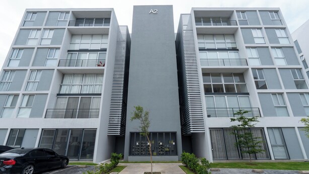 A modern building with a central entrance, two side wings, and a car parked in front. - Modern Apartment with Terrace and Pool  (Tlajomulco de Zúñiga)