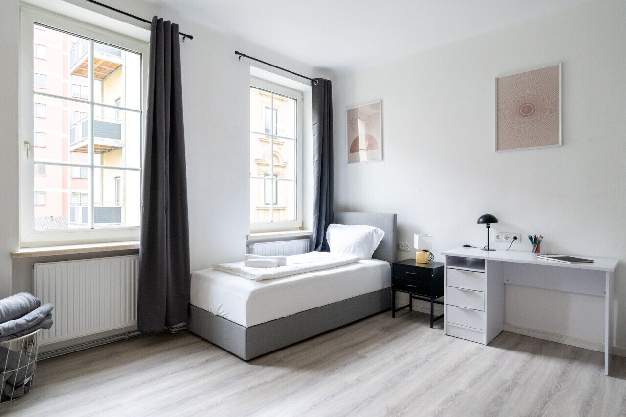 1 habitación, escritorio, tabla de planchar con plancha y cuna de viaje 