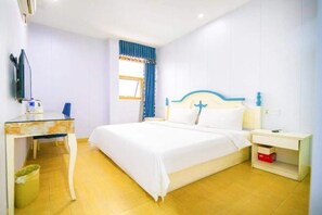 Une chambre à coucher comprenant un lit, une table de chevet, une commode et un bureau avec une chaise.