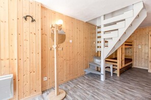 A wooden interior with a staircase, a floor lamp, and a radiator. - 70m from ski slopes, Ground floor, balcony, tv, 43m², La Clusaz (La Clusaz)