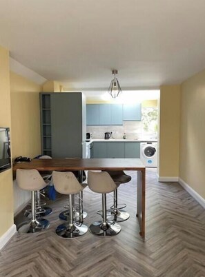 Enjoy meals at the kitchen table with four stools.