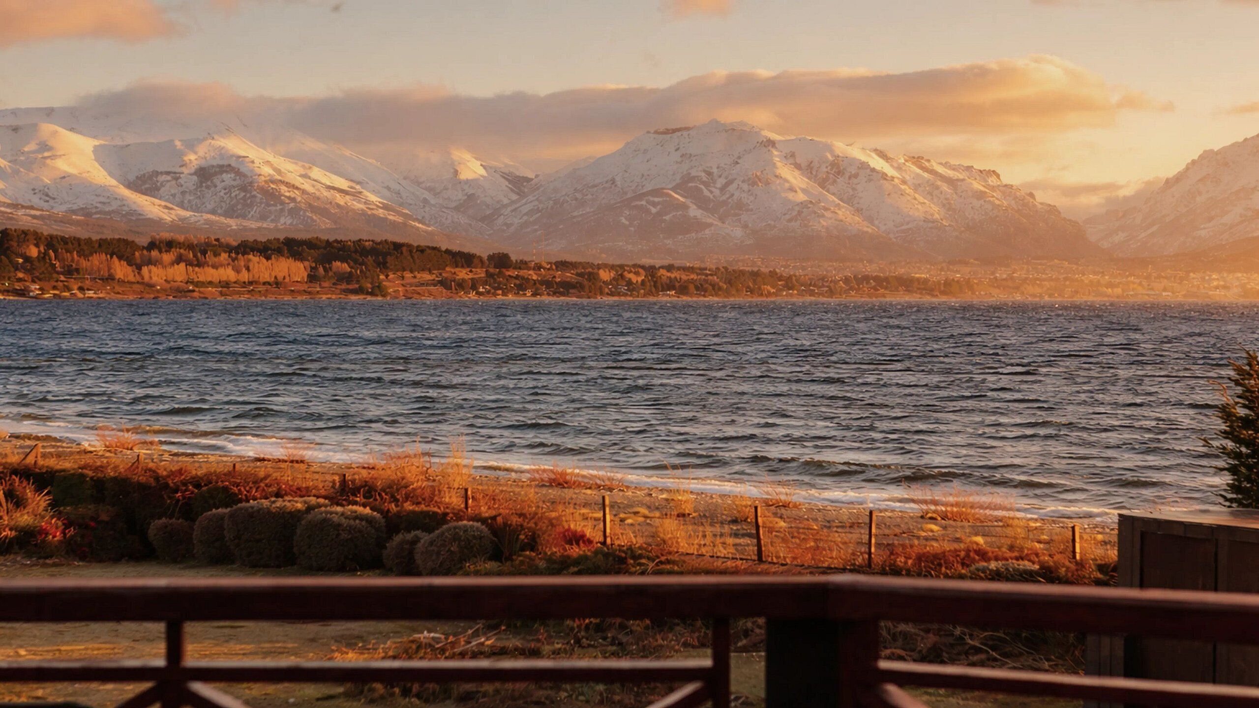 A lakeside view with mountains in the background.