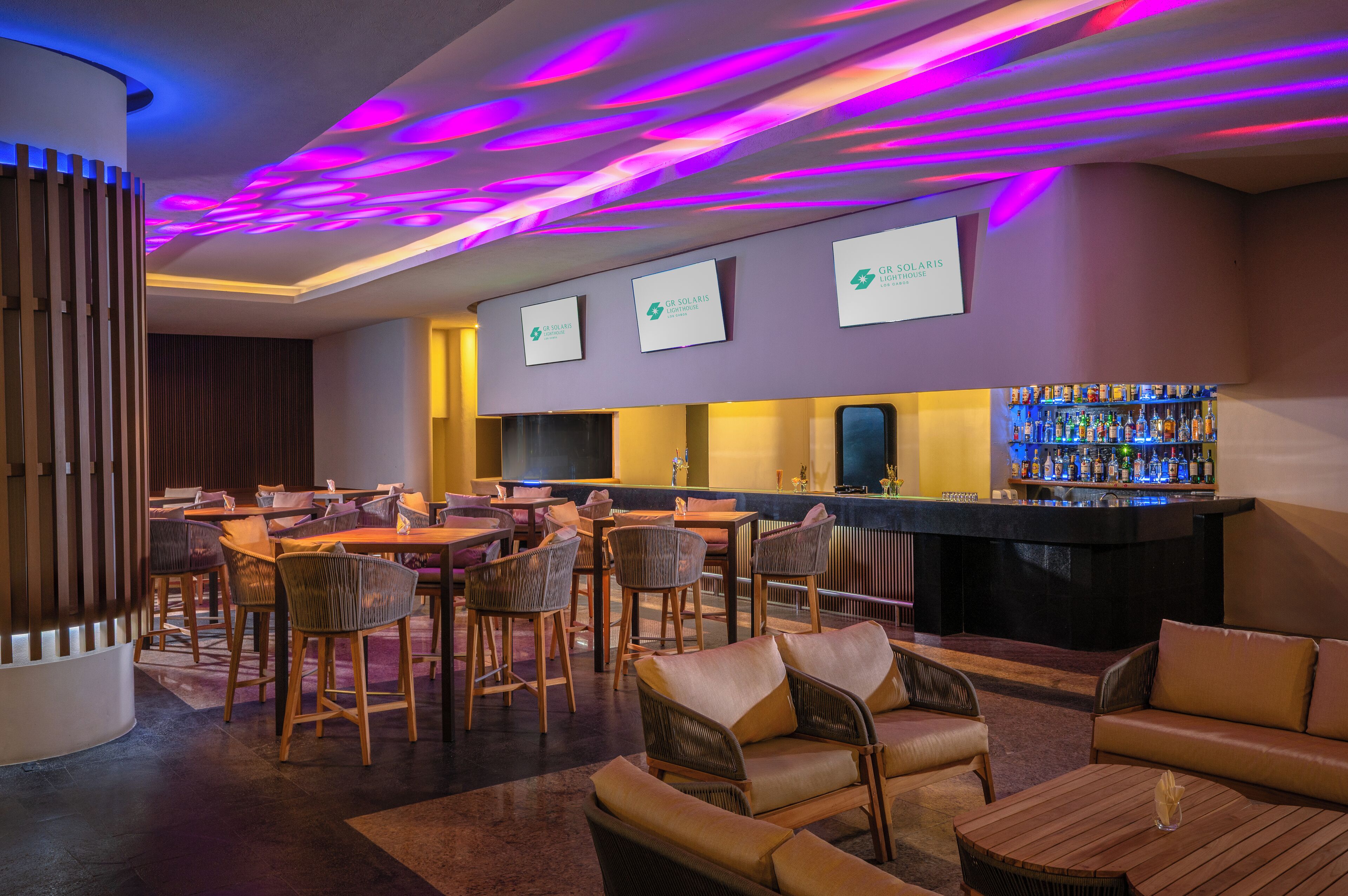 A bar area with seating, a bar counter, and three screens displaying the Solaris logo.