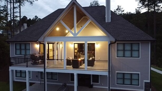 A two-story house with a balcony, large windows, and a chimney. - Brand new luxury craftsman. 5000 sqft with 5 bedrooms, 5 baths and bunk room. (Six Mile)