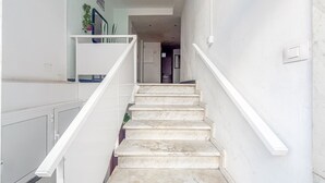A staircase with white railings leading to a landing.