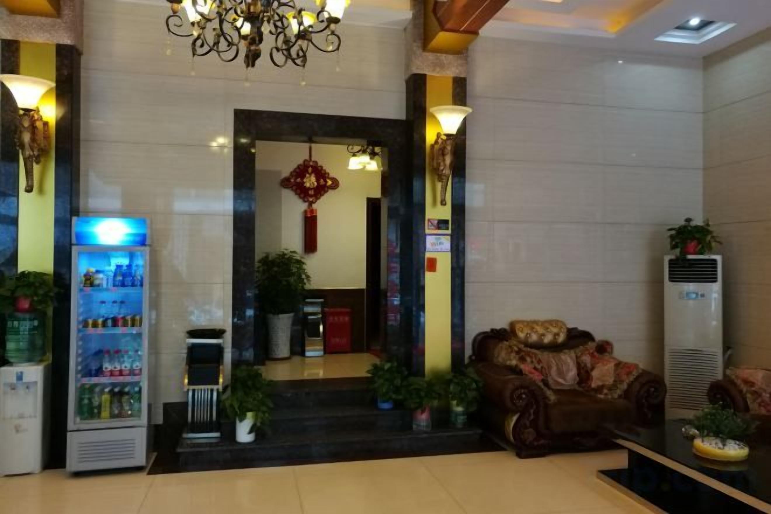 A lobby with a vending machine, a sofa, and a large air conditioning unit.