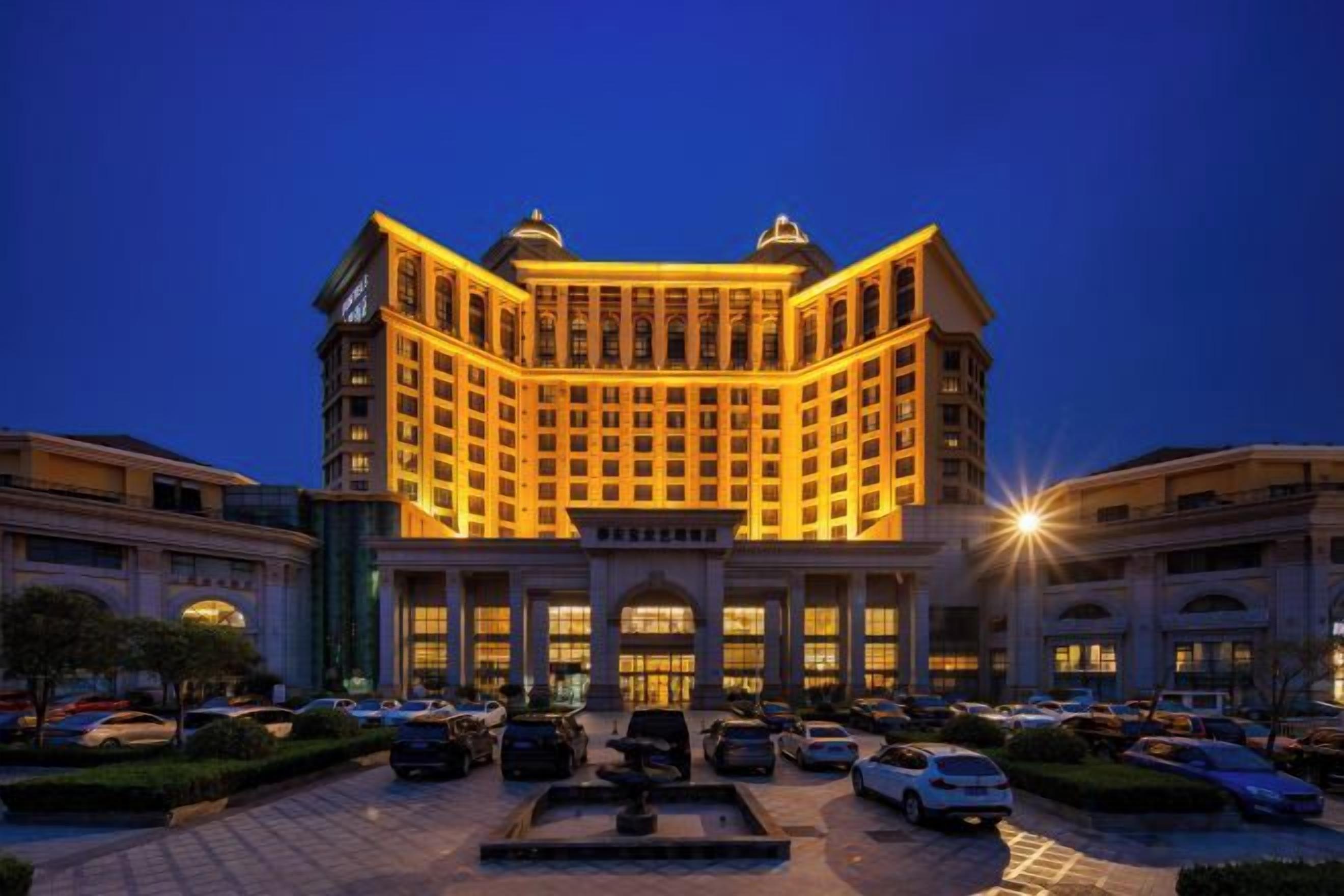A multi-story hotel with a symmetrical facade, large windows, and a central entrance.