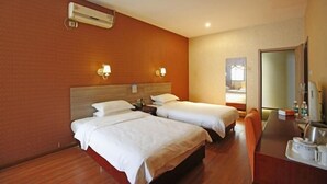 A hotel room with two beds, a desk, a chair, an air conditioning unit, and a mirror. - Blue City Exepress Hotel (Chengdu)