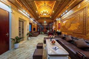 Experience the grandeur of our lobby, featuring a stunning chandelier, plush seating areas, and elegant decor.
