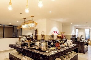 A modern kitchen with a marble countertop, hanging light fixtures, and a variety of kitchen appliances and utensils. - Bo Man Hotel (Pu'er)