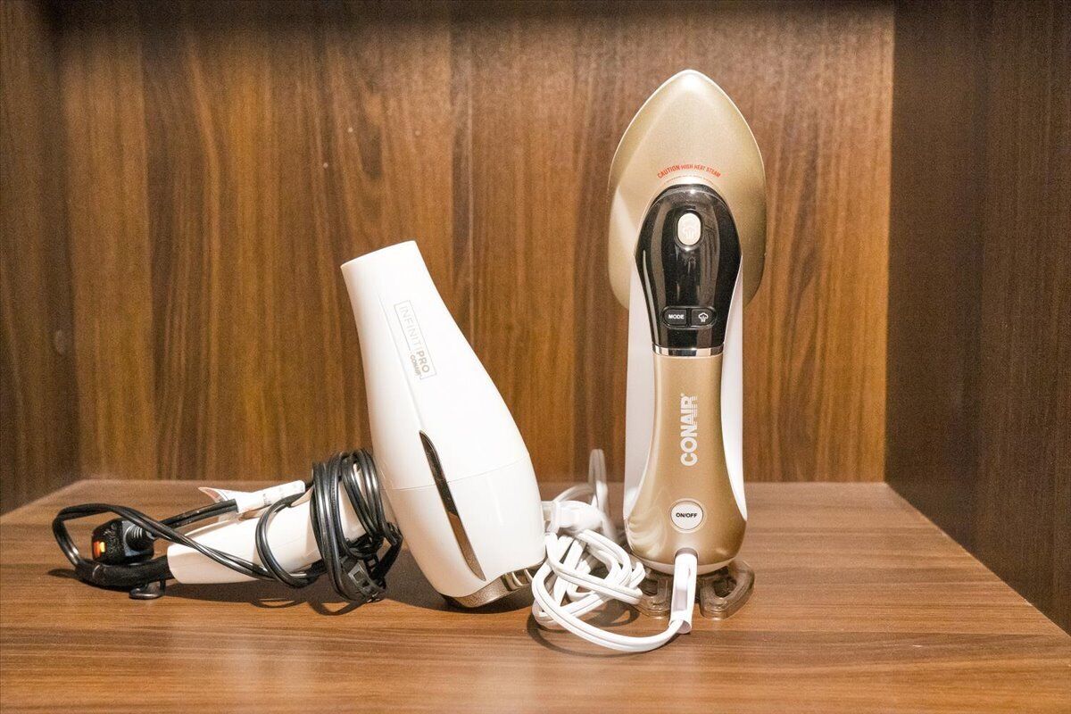 A device with a black and white design, a control button, and a power cord on a wooden surface.