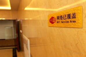 A sign indicating a WiFi service area in a hotel lobby. - Wansheng Hotel (Yuanqu)