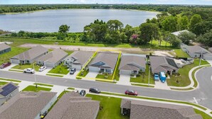 A residential area with houses, a road, and a lake in the background. -  - HIDDEN GEM - Spacious, minimal and clean! Legoland + Disney (Wahneta)