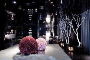 A corridor with a snow-covered path, illuminated trees, and a traditional pagoda structure in the background. - Wego Funtel (Taipei)