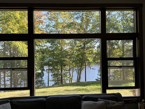 BEAUTIFUL lake front home with a private beach, dock and large yard