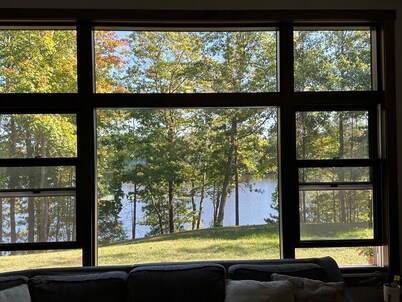 BEAUTIFUL lake front home with a private beach, dock and large yard