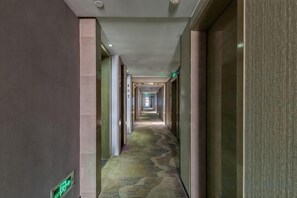 A long, narrow hallway with a patterned carpet and doors on both sides. - Tianhai Hotel (Jiujiang The Second Yangtze River Bridge Harbor) (Jiujiang)