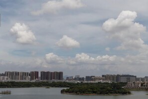 A cityscape with high-rise buildings and a body of water. - XiDi Hotel (Shenzhen)