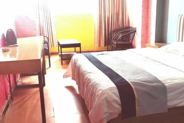 A hotel room with a bed, a desk, a chair, and a small table. - Jiachengyouxuan Hotel Apartment (Zhengzhou Erqi Square Metro Station) (Zhengzhou)