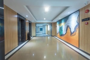 A long, well-lit corridor with a modern design, leading to multiple rooms or areas. - Lanli Baihe Hotel (xindacheng 2 Road) (Yangjiang)