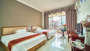 A hotel room with two beds, a desk, a chair, a TV, and a window with curtains.