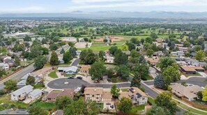 A residential area with houses, a baseball field, and a large building with a circular driveway. - Themed Bedrooms, Movie Room & Firepit Yard (Westminster)