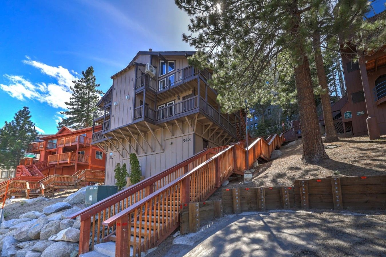 A multi-story building with a wooden staircase leading to a balcony.