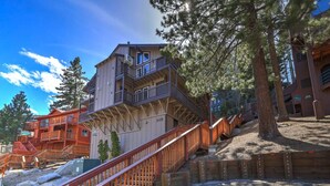 A multi-level wooden building with a staircase leading to a balcony. - Ski-In Heavenly Condo | Cozy 3BR | Sleeps 8 (Stateline)