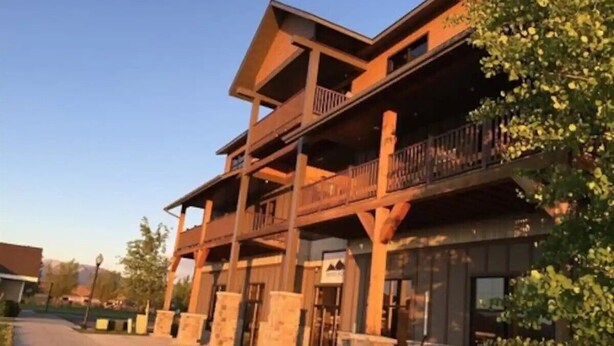 A multi-story building with a wooden facade and balconies.