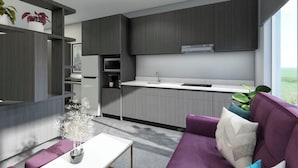 Una cocina moderna con armarios de madera oscura, una encimera blanca y una estufa integrada. En primer plano, un sofá púrpura con un jarrón de flores y una mesita.