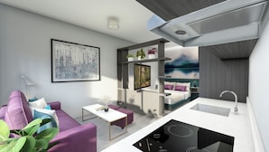 Un espacio habitable moderno y funcional con cama, una zona de descanso pequeña, kitchenette y baño.