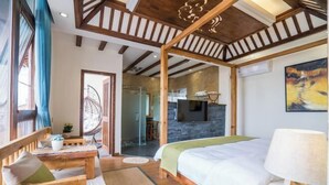 A modern bedroom with a large bed, wooden furniture, and a stone accent wall. - Yuetu Shishanju, Lijiang Ancient City (Lijiang)