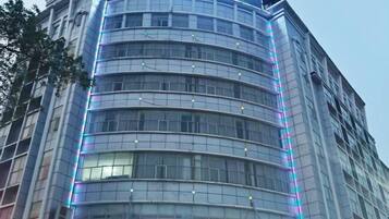 A modern building with a curved facade and multiple floors.