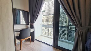 A modern hotel room with a large window, a desk, and a chair. - Southlink Lifestyle Apartment Bangsar (Kuala Lumpur)