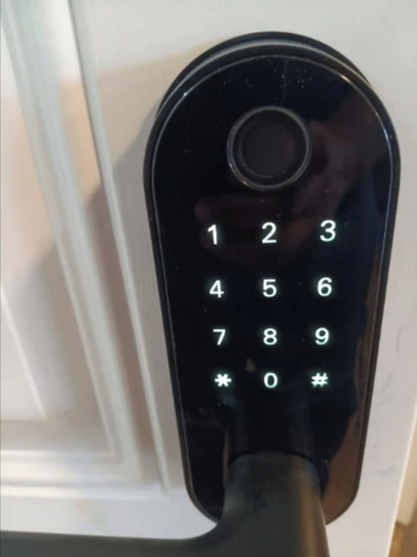 Un teclado numérico negro en una cerradura de puerta.
