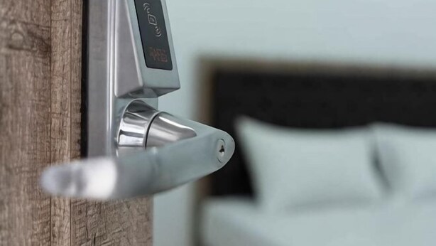A door handle with a digital lock mechanism. - Hotel Padma Tangerang (Karawaci)