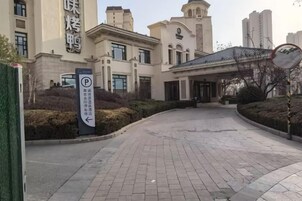 A building entrance with a paved driveway leading to a covered entrance area.