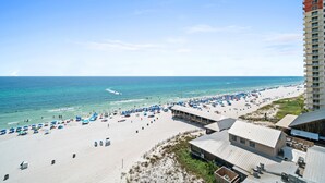 A beach with a high-rise hotel in the background.