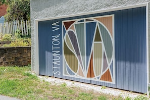 A building with a blue exterior and a large, stylized logo on the side.