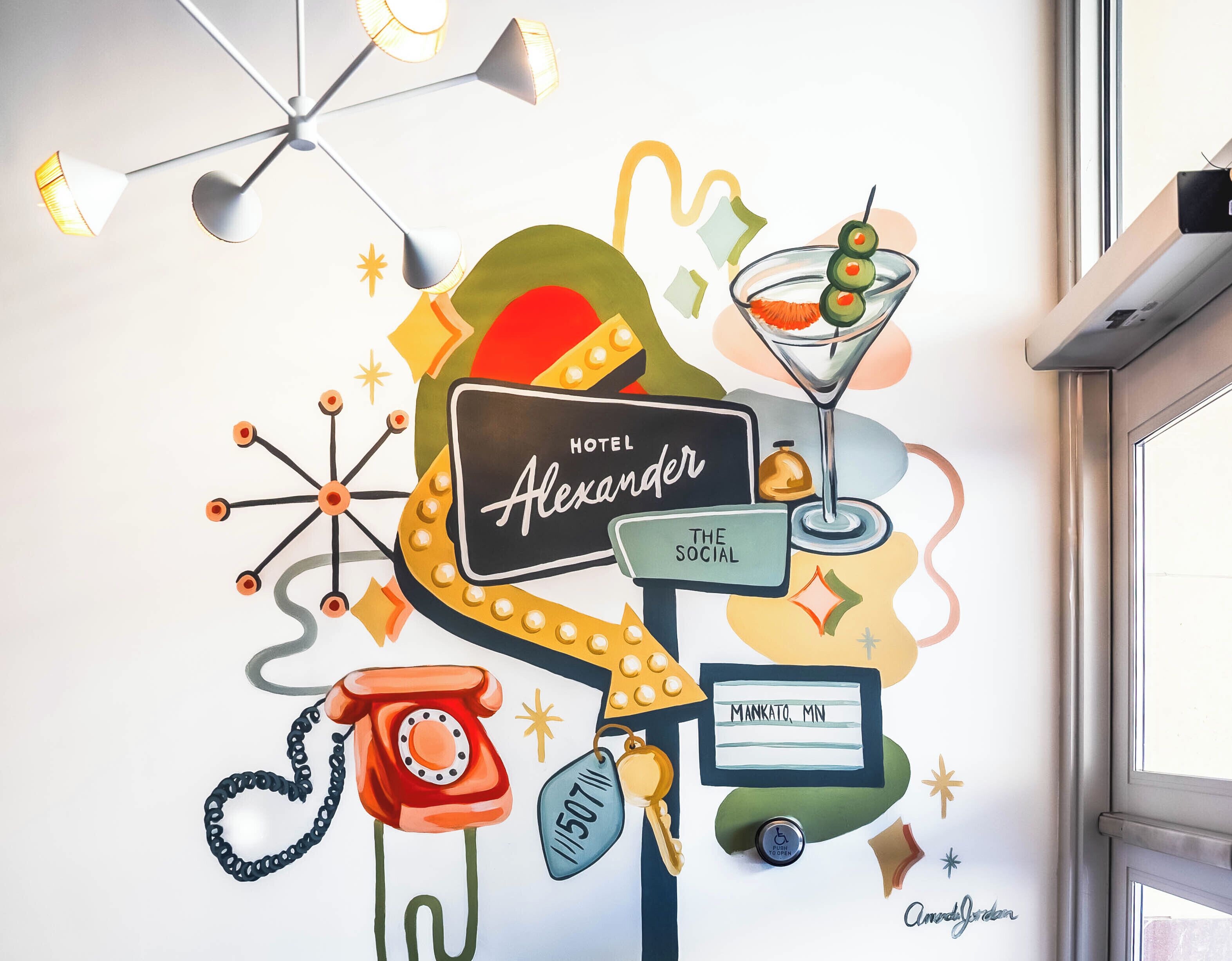 A wall with a sign reading 'Hotel Alexander,' a martini glass, a red telephone, and a 'Push Open' sign.