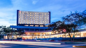 A multi-story hotel with a prominent 'Fiesta Inn' sign, featuring a modern architectural design with a flat roof and a series of windows. - Fiesta Inn Mazatlán (Mazatlán)