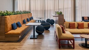 A modern lounge area with sofas, tables, and decorative balls. - Fiesta Inn Mazatlán (Mazatlán)