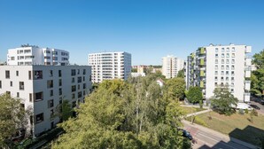 A high-rise residential building with multiple balconies and a clear view of the surrounding area.