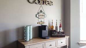 A coffee-themed decor with a coffee machine, a sign reading "Espresso Paris," and a "Coffee Bar" box on a wooden cabinet.