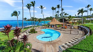 A resort with a swimming pool, lounge chairs, and a view of the ocean. - Garden views, island vibes near Napili Bay Beach (Lahaina)